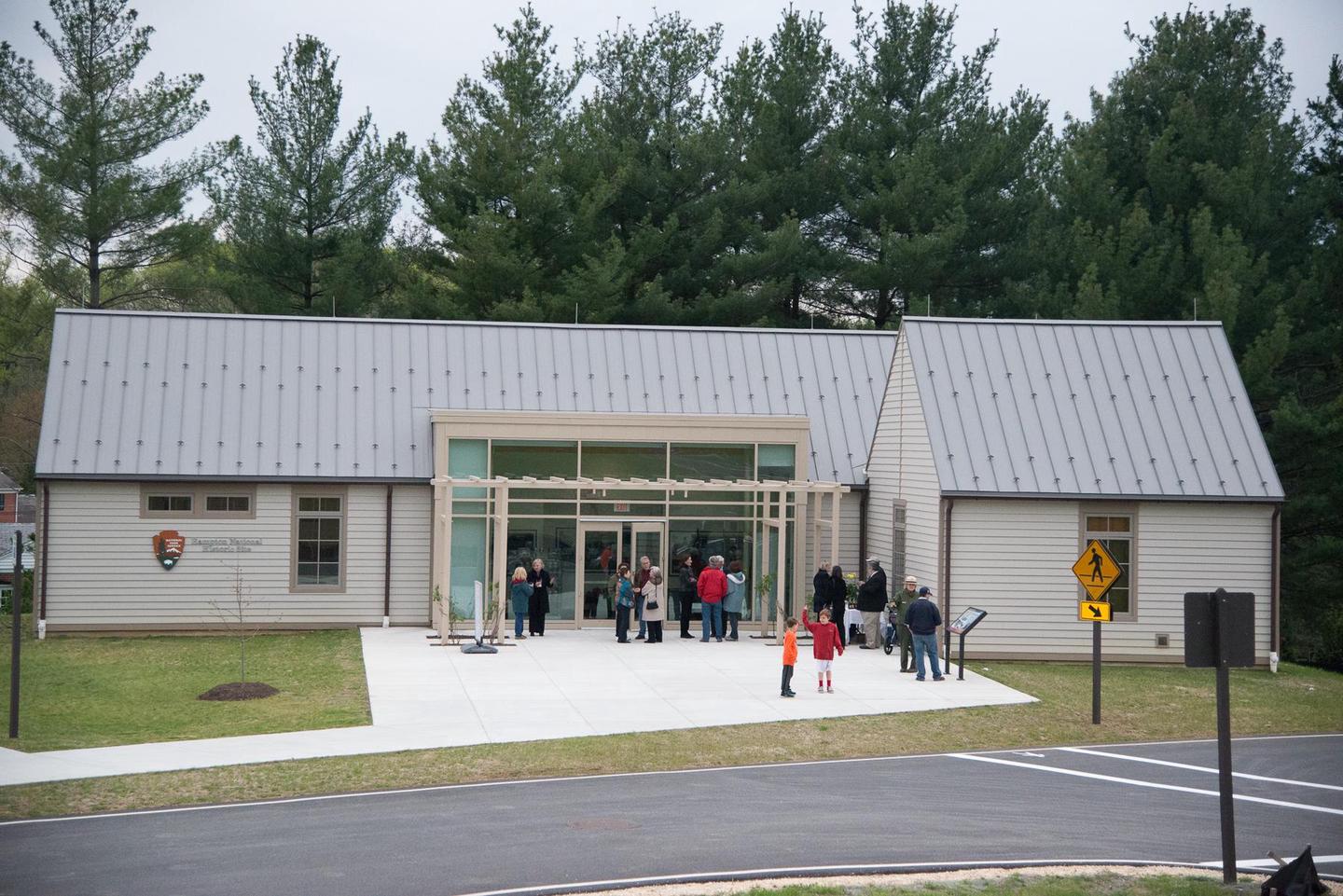 HAMP VCSA group of visitors stand in front of the Hampton visitor contact station.