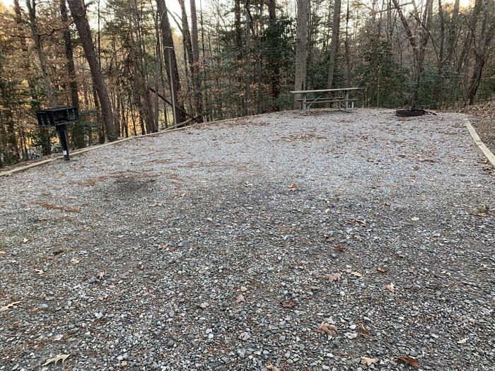 Gravel site with table, fire pit, grill
