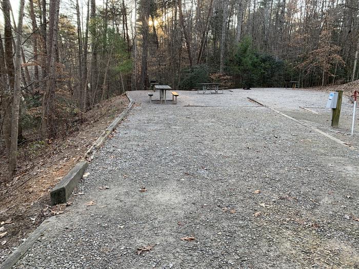 Gravel site with fire pit, table, grill 