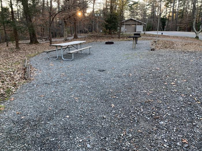 Gravel site with table, fire pit, grill 