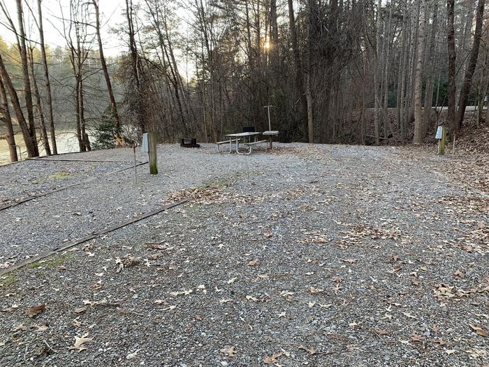 Gravel pull in and site with fire pit, table, grill 