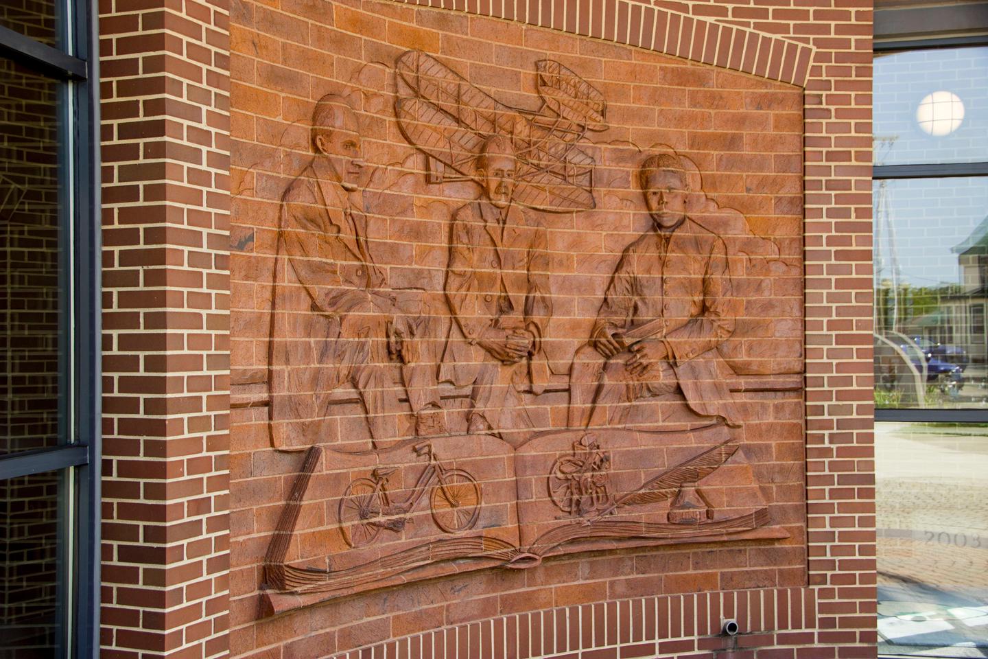 Wrights and Dunbar muralAn artistic mural etched out of the red brick wall at the Wright-Dunbar Interpretive Center entrance.