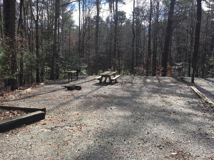 Gravel site with fire pit, table, grill 