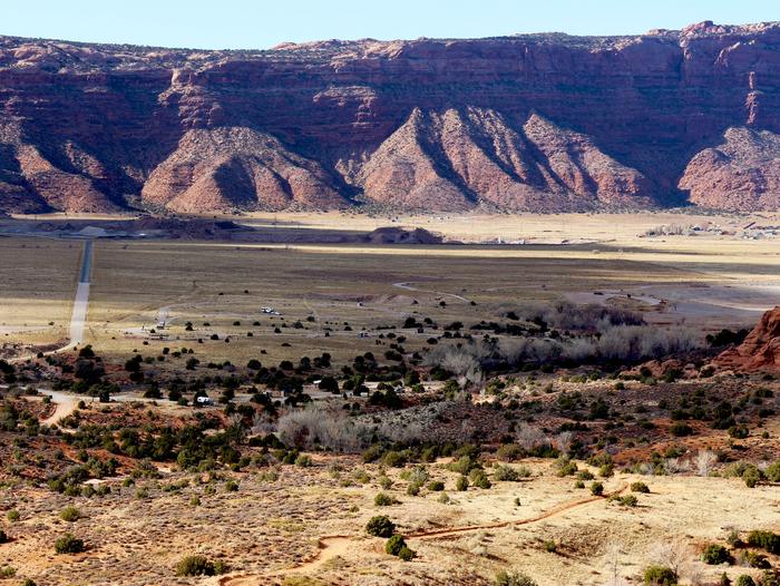 Overview of Ken's Lake Campground with red rock cliffs lining the horizon.