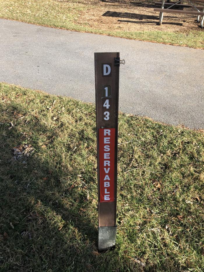 Site marker for D143: If you reserve this site, your camping pass will be attached to this marker.  When you check out, drop your pass at the registration office.If you reserve this site, your camping pass will be attached to this marker.  When you check out, drop your pass at the registration office.