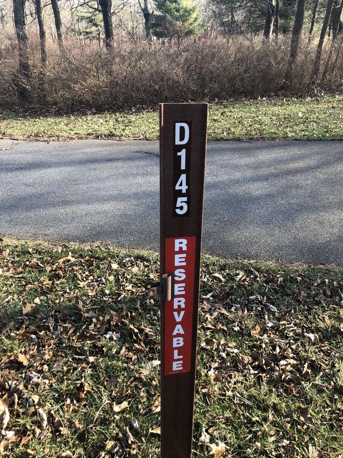 D145 site marker: If you reserve this site, your camping pass will be attached to this marker.  When you check out, drop your pass at the registration office.If you reserve this site, your camping pass will be attached to this marker.  When you check out, drop your pass at the registration office.