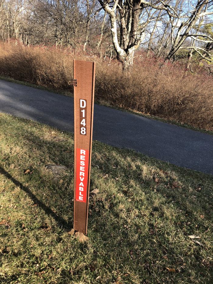 D148 site marker; If you reserve this site, your camping pass will be attached to this marker.  When you check out, drop your pass at the registration office.