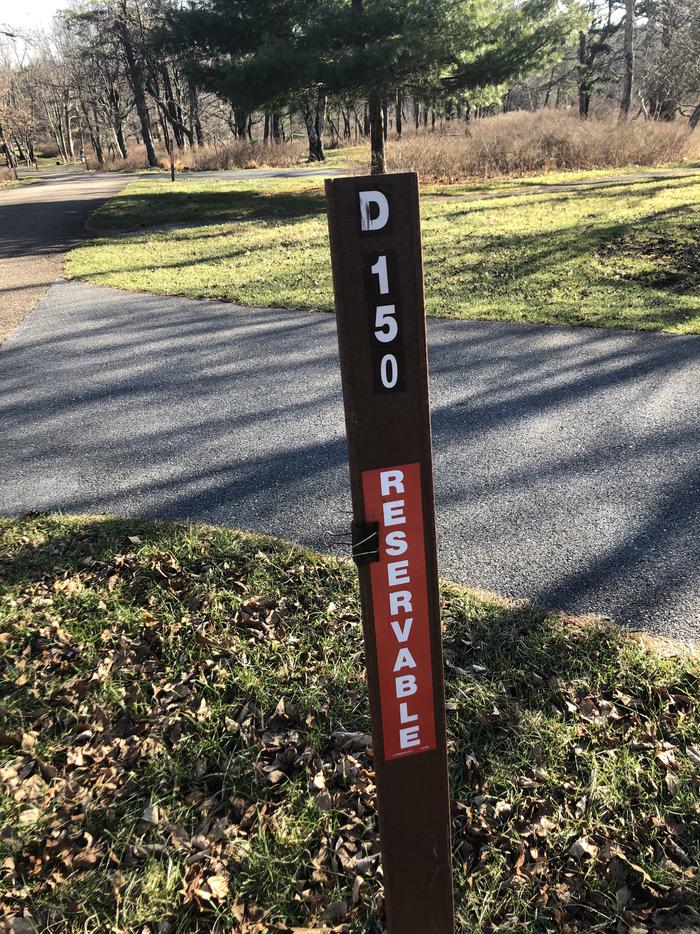 D150 Site marker; If you reserve this site, your camping pass will be attached to this marker.  When you check out, drop your pass at the registration office.