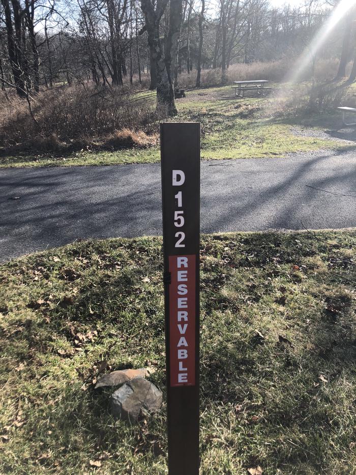 D152 site marker; If you reserve this site, your camping pass will be attached to this marker.  When you check out, drop your pass at the registration office.
