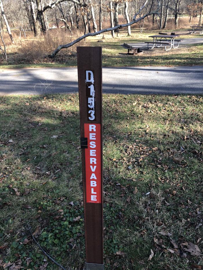 D153 site marker; If you reserve this site, your camping pass will be attached to this marker.  When you check out, drop your pass at the registration office.