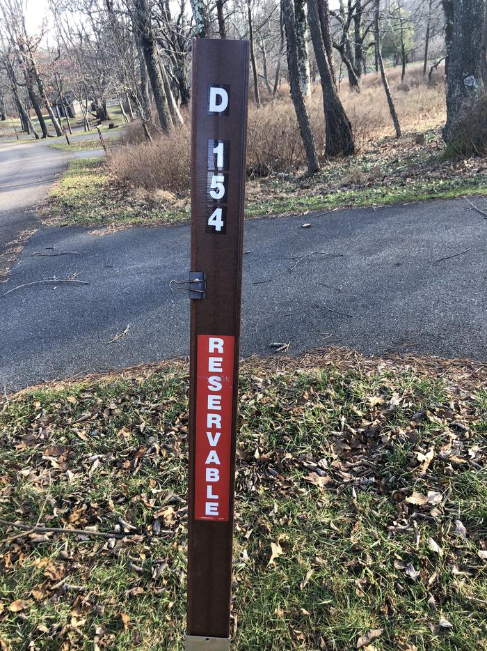 D154 site marker; If you reserve this site, your camping pass will be attached to this marker.  When you check out, drop your pass at the registration office.