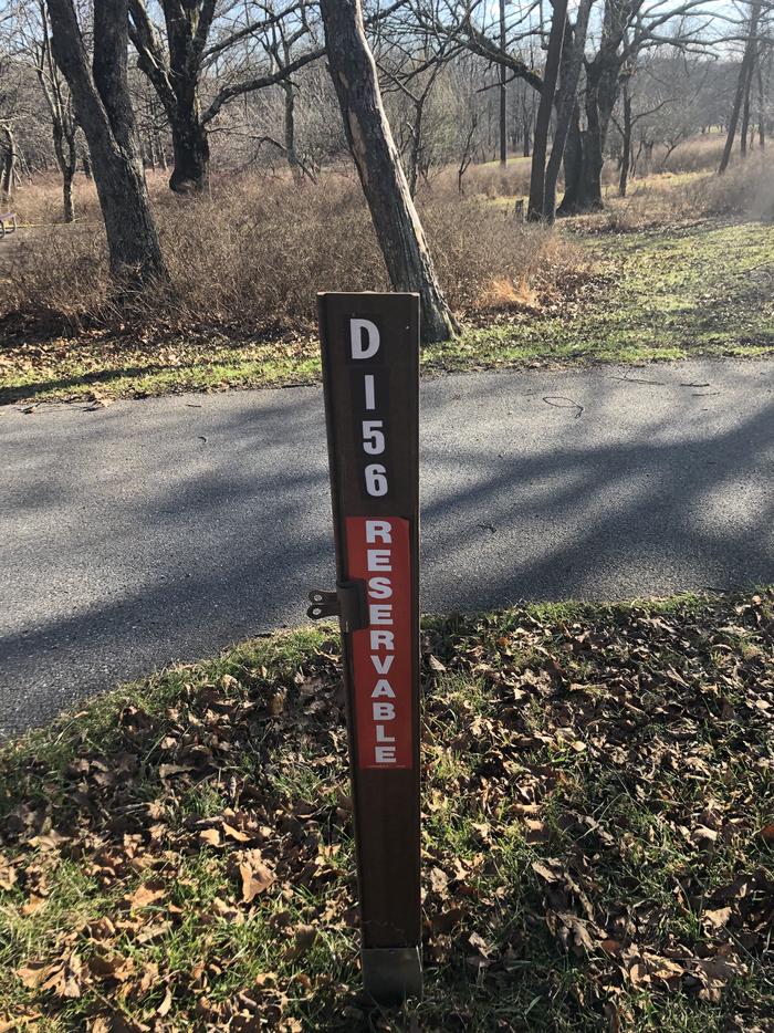 D156 site marker; If you reserve this site, your camping pass will be attached to this marker.  When you check out, drop your pass at the registration office.If you reserve this site, your camping pass will be attached to this marker.  When you check out, drop your pass at the registration office.. 