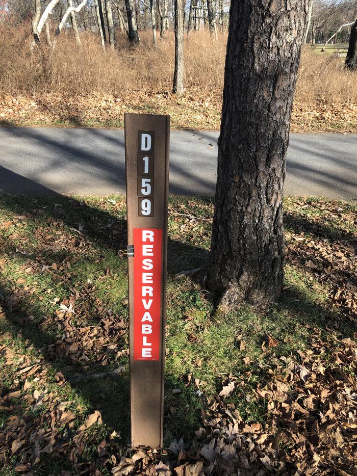 D159 site marker; If you reserve this site, your camping pass will be attached to this marker.  When you check out, drop your pass at the registration office.