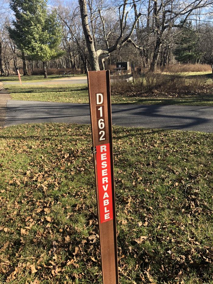 D162 site marker; If you reserve this site, your camping pass will be attached to this marker.  When you check out, drop your pass at the registration office.If you reserve this site, your camping pass will be attached to this marker.  When you check out, drop your pass at the registration office.