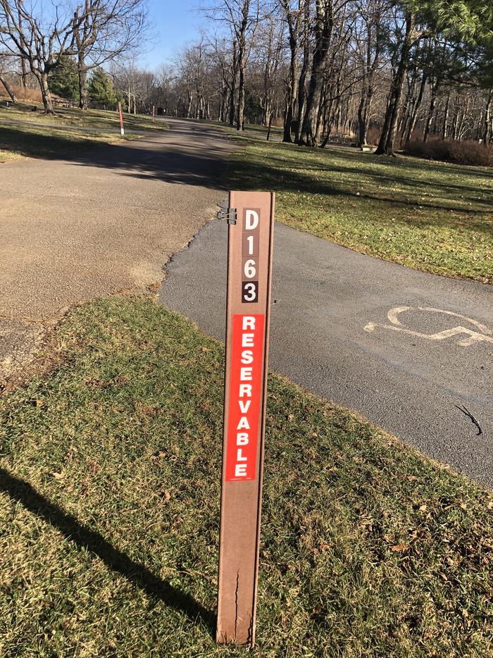 D163 site marker; If you reserve this site, your camping pass will be attached to this marker.  When you check out, drop your pass at the registration office.