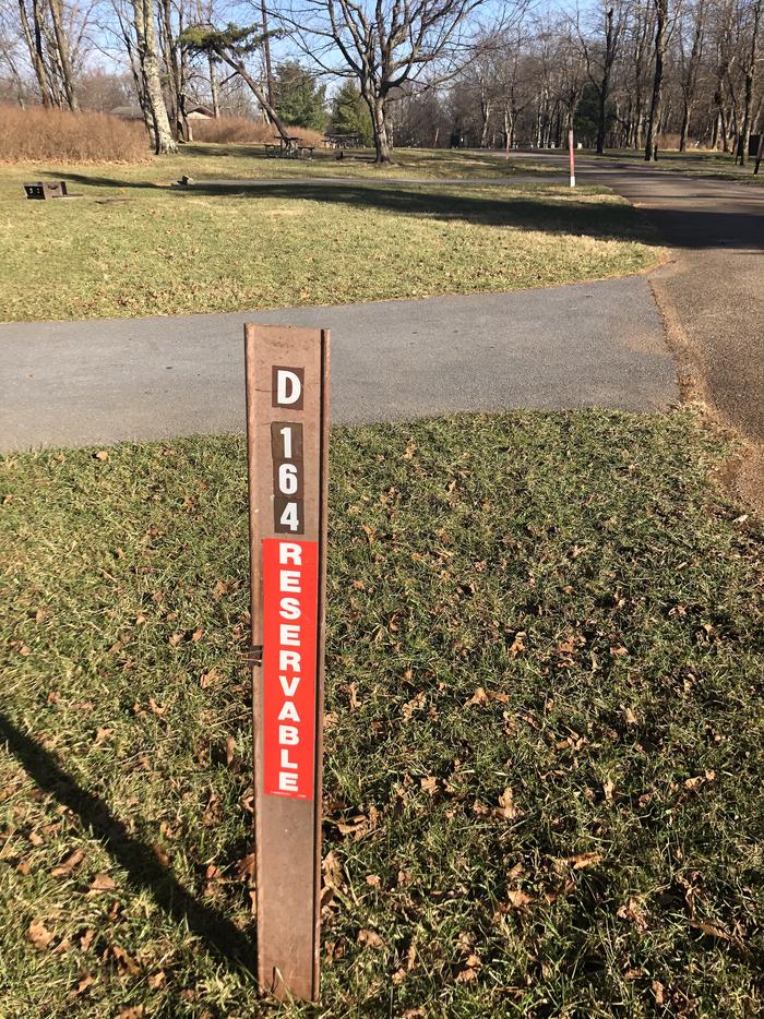 D164 site marker; If you reserve this site, your camping pass will be attached to this marker.  When you check out, drop your pass at the registration office.