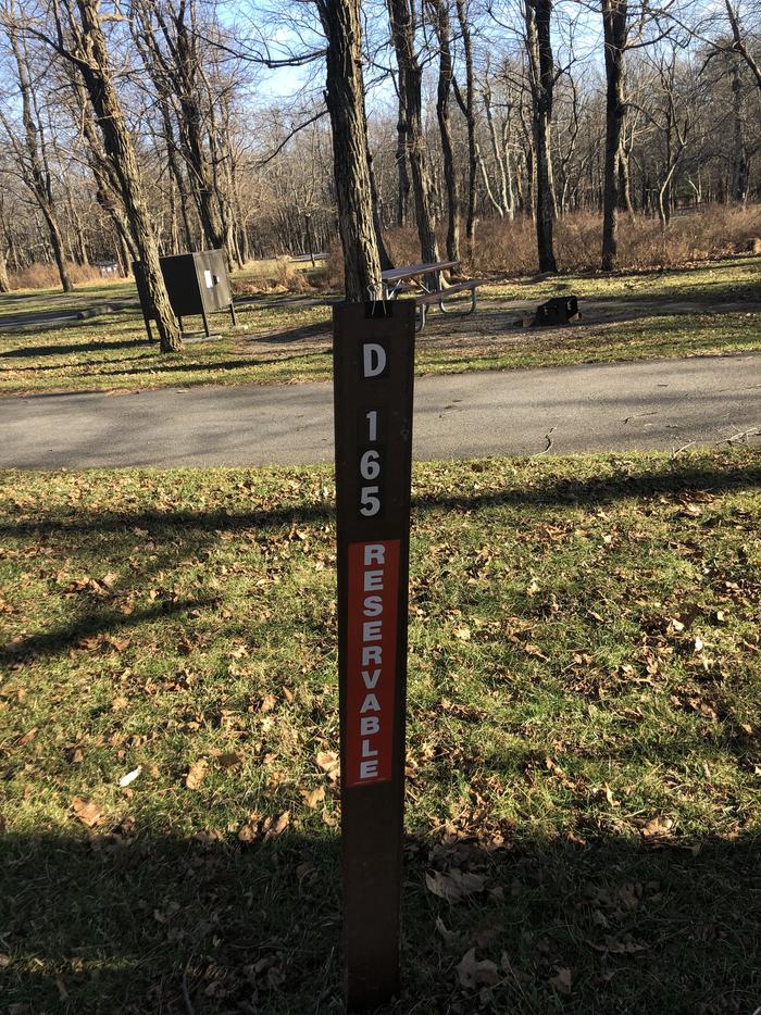 D165 site maker; If you reserve this site, your camping pass will be attached to this marker.  When you check out, drop your pass at the registration office.If you reserve this site, your camping pass will be attached to this marker.  When you check out, drop your pass at the registration office.