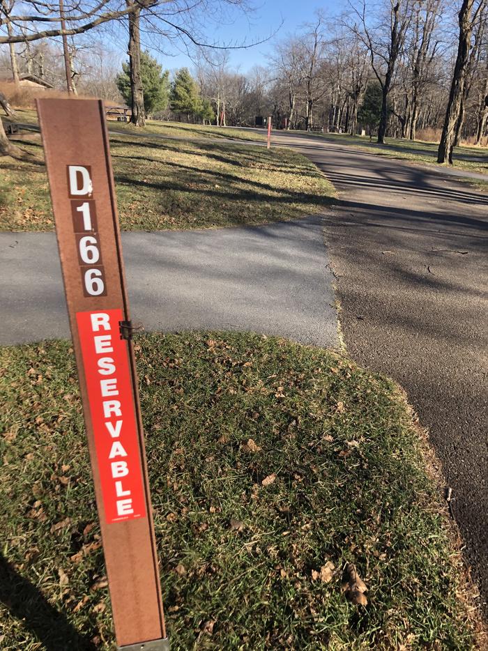 D166 site marker; If you reserve this site, your camping pass will be attached to this marker.  When you check out, drop your pass at the registration office.