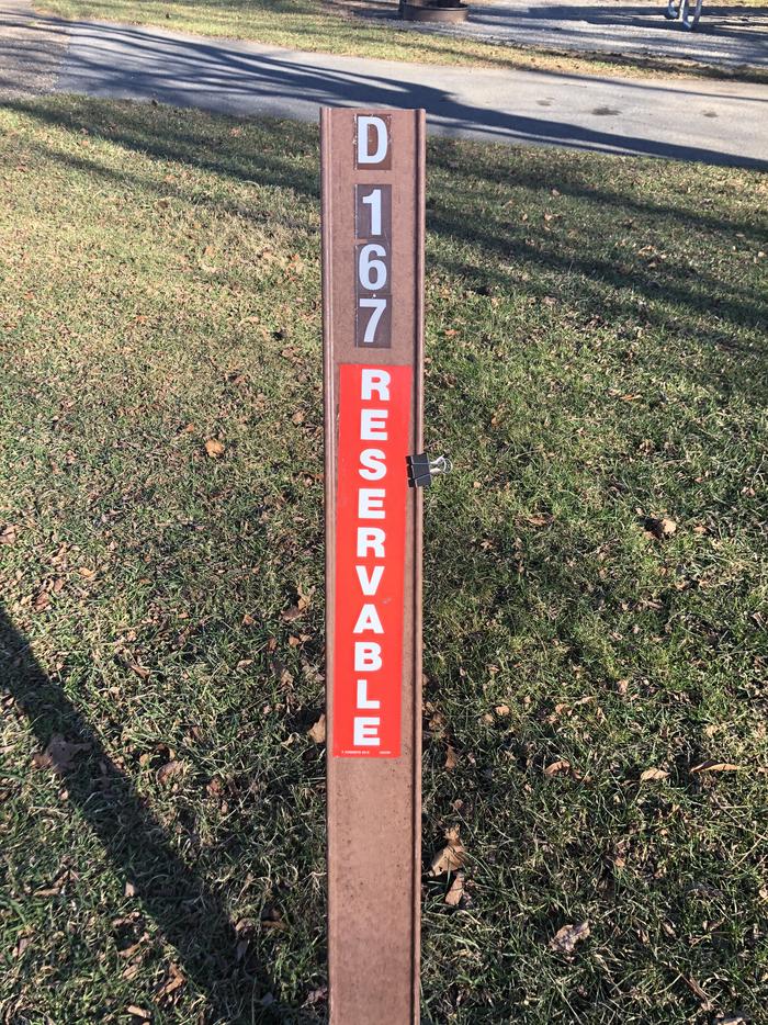D167 site marker; If you reserve this site, your camping pass will be attached to this marker.  When you check out, drop your pass at the registration office.