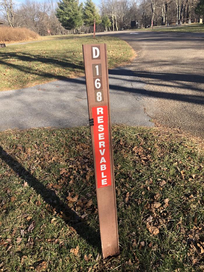 D168 site marker; If you reserve this site, your camping pass will be attached to this marker.  When you check out, drop your pass at the registration office.