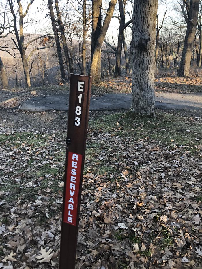 Site marker for Campsite E183; If you reserve this site, your camping pass will be attached to this maker.  When you check out drop your camping pass at the registration office.