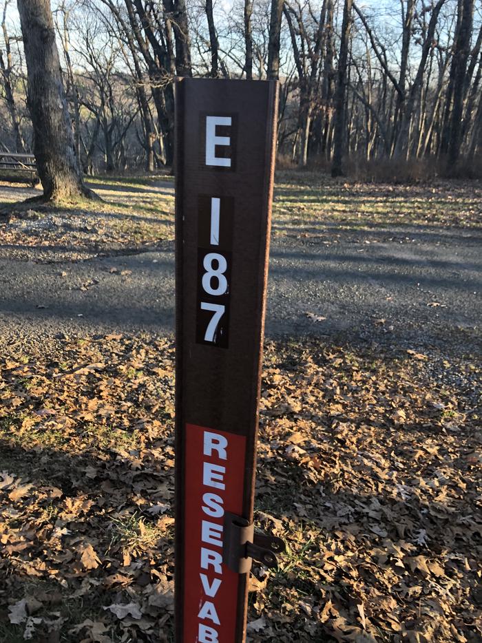 site marker for Campsite E187; If you reserve this site, your camping pass will be attached to this maker.  When you check out drop your camping pass at the registration office.
