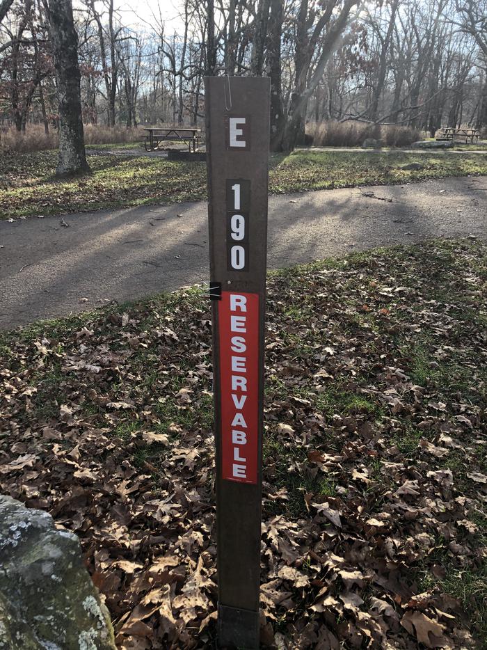 Site marker for Campsite E190;If you reserve this site, your camping pass will be attached to this maker.  When you check out drop your camping pass at the registration office. 
