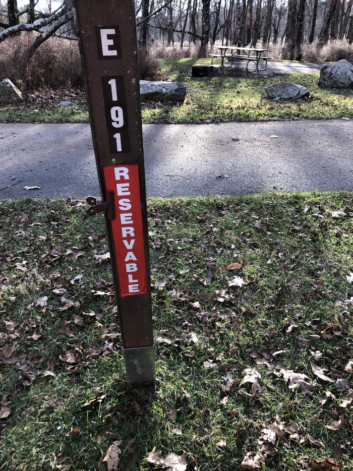 Site marker for Campsite E191; If you reserve this site, your camping pass will be attached to this maker.  When you check out drop your camping pass at the registration office.
