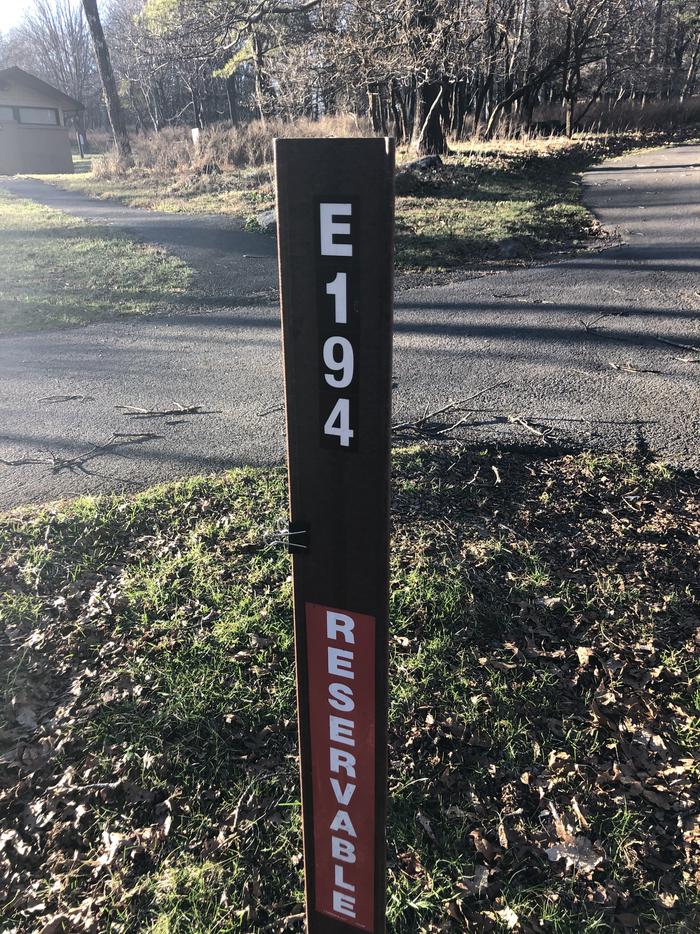 site marker for Campsite E194; If you reserve this site, your camping pass will be attached to this maker.  When you check out drop your camping pass at the registration office.