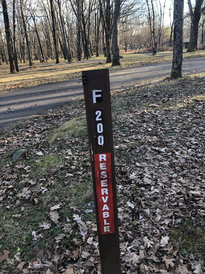 site marker for Campsite F200; If you reserve this site, your camping pass will be attached to this maker.  When you check out drop your camping pass at the registration office.