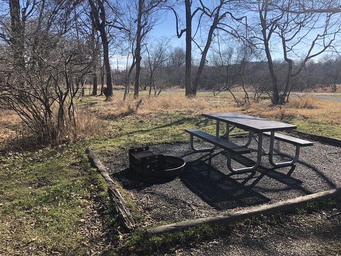View of B115Site has a driveway, tent pad, picnic table, and fire pit. 