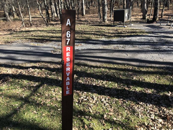 Site marker for A67; If you reserve this site, your camping pass will be attached to this site marker.  When you check out, drop your pass off at the registration office.