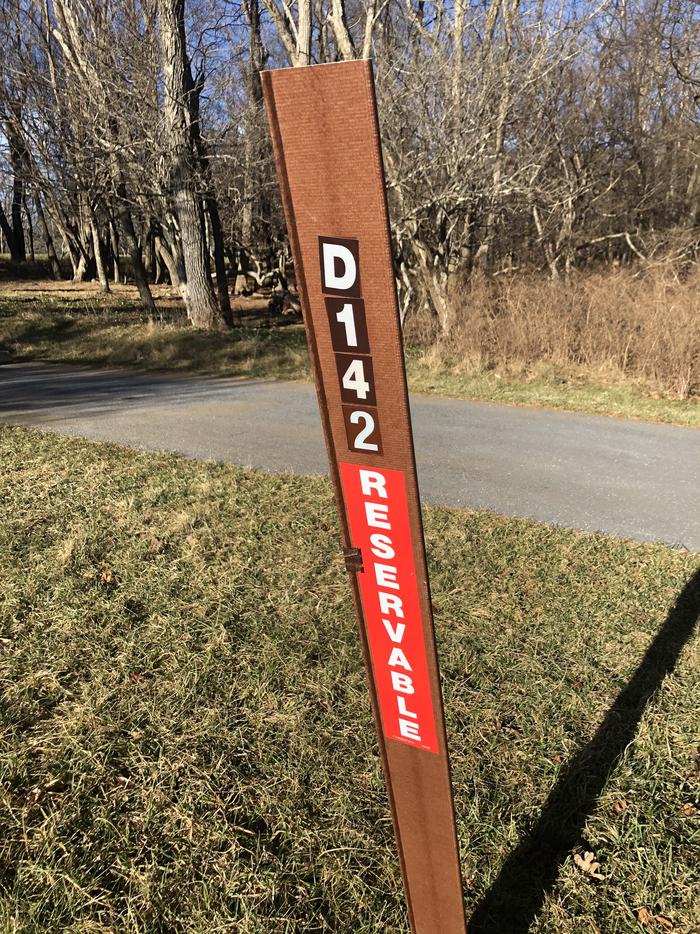 D142 site marker; If you reserve this site, your camping pass will be attached to this marker.  When you check out, drop your pass at the registration office.