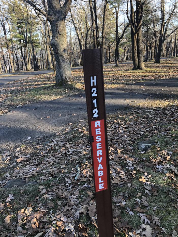 Site marker for campsite H212; If you reserve this site, your camping pass will be attached to this maker.  When you check out drop your camping pass at the registration office.