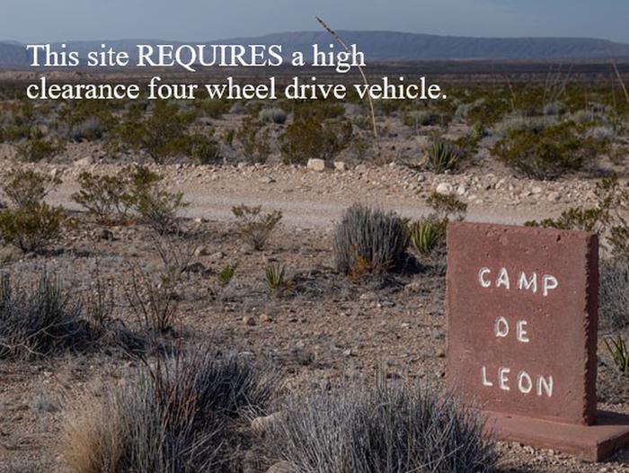 Campsite sign with mountains in the background w/ warningCamp de Leon sign, high clearance four wheel drive required.
