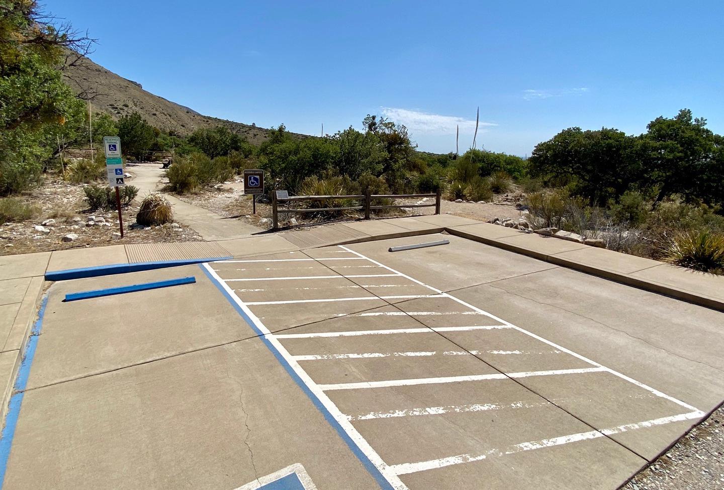 Group site #1 with parking space for accessibility needs and a paved trail leading to the picnic table and tent pad.Parking space for accessibility needs and a paved trail leading to the picnic table and tent pad.