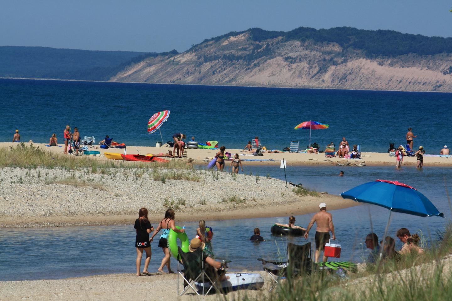 A perfect beach day at Platte River PointBright-colored umbrellas, bathing suits and floats make a festive day at the beach