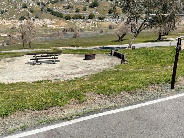 Site has picnic table and fire ring. Open site with no shade.Campsite with picnic table and fire ring. Two parking spaces are to the right of the site area. Site is across from Bath House #2. 