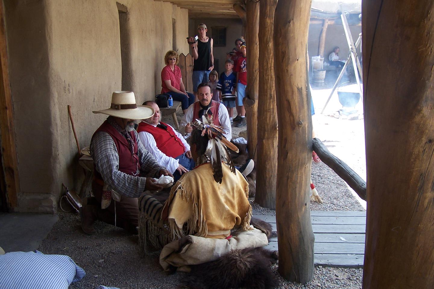 A Lakota warrior barters with the traders in the fort plazaTrade with a Lakota warrior for trade goods from around the world.