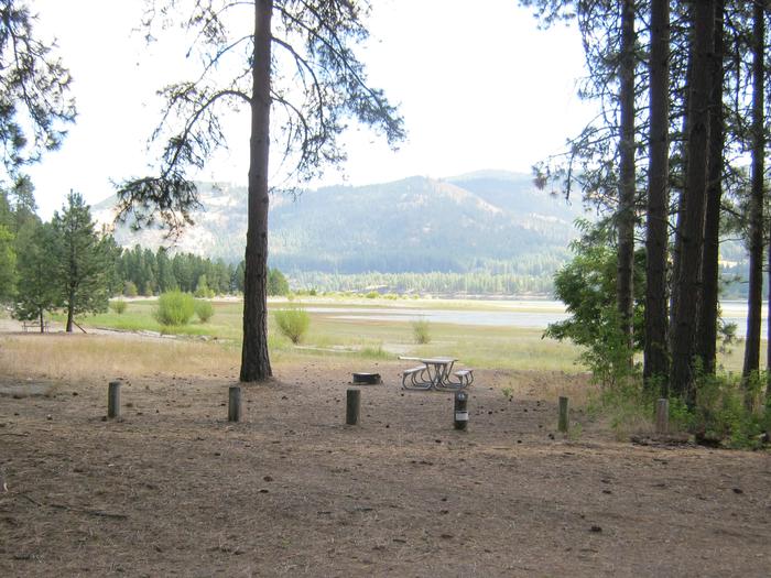 Site 13. Walk in. Trees and lake in the background.