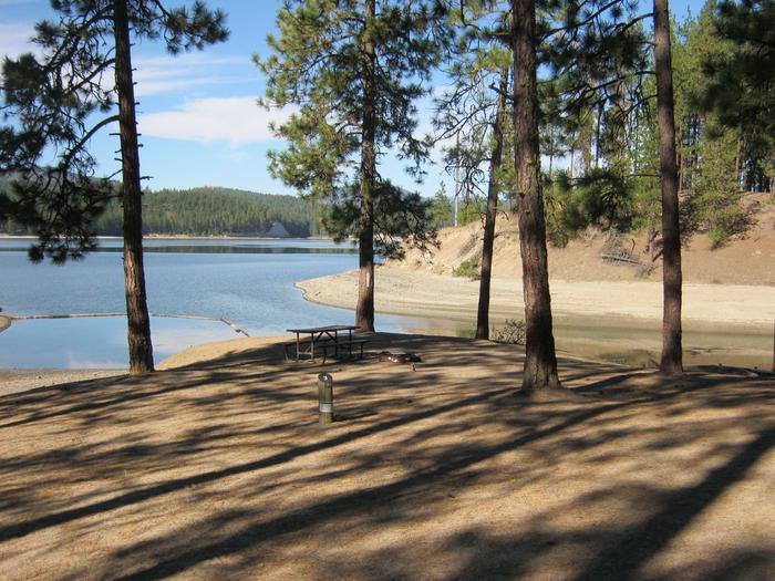 Site 3. Walk in. Trees and lake in the background.