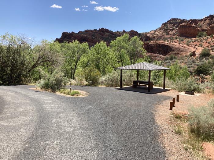 Site 6 provides one picnic table with a shade ramada. There is a fire ring with grill, and a water spigot. Pull through parking accommodates an RV, or two vehicles, or a travel trailer and tow vehicle. There is room for one large tent or a couple small/medium sized tents. Site 6 Driveway