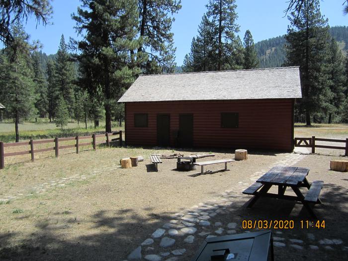 A fenced yard with a campfire ring and picnic tables.Barber Flat features a large, flat yard with picnic tables and a campfire ring.  (Closed maintenance shed in background)
