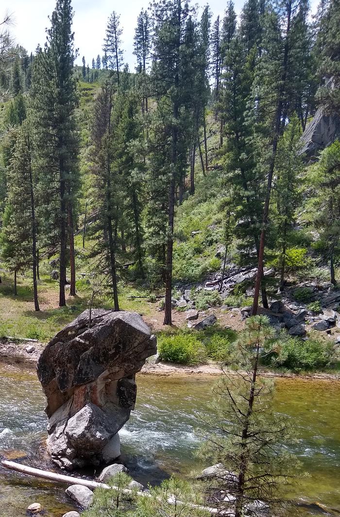 A hand-shaped rock formation rising from a river.Although not within the campground, Black Rock Campground is named after this nearby formation rising from the North Fork of the Boise River.
