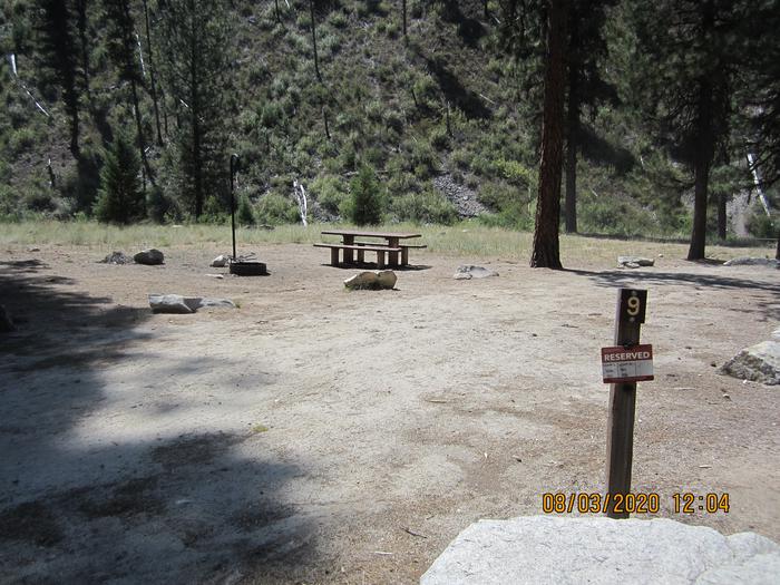 A sunny campsite near a river.Site 9 also features a long driveway and a lot of sun.  The North Fork of the Boise River flows behind it.