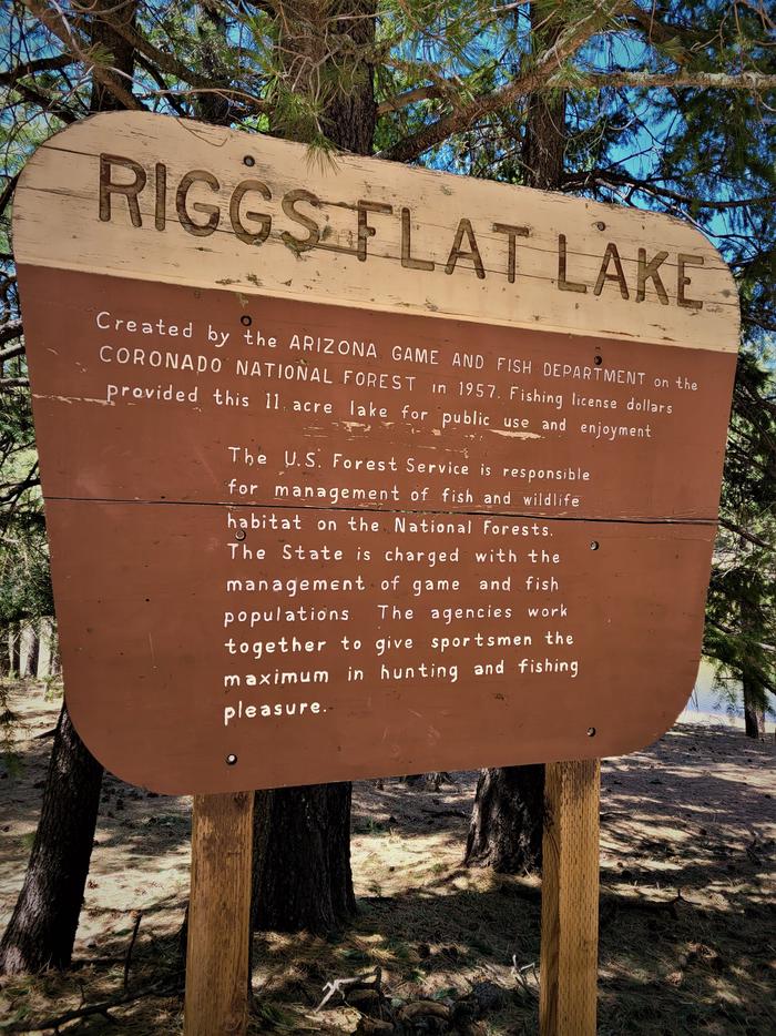 A sign detailing the history and upkeep of Riggs Flat Lake.A sign detailing the history and upkeep of Riggs Flat Lake. The 11-acre lake, created by the Arizona Fish and Game Department, is stocked with a number of different fish species. 