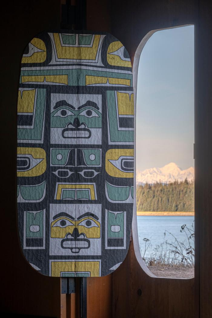 Mt Fairweather from Inside the Huna Tribal HouseThe entrance door of the Huna Tribal House pulls open from inside to reveal Mount Fairweather