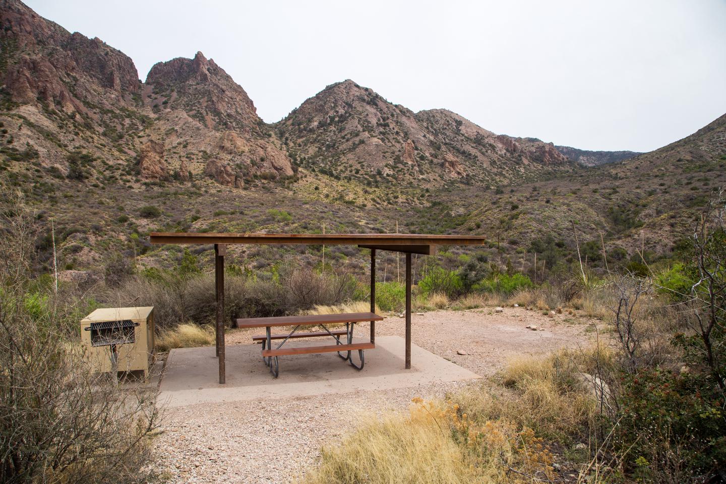 Mountains surround this campground and site. Shade shelter provides added sun protection.