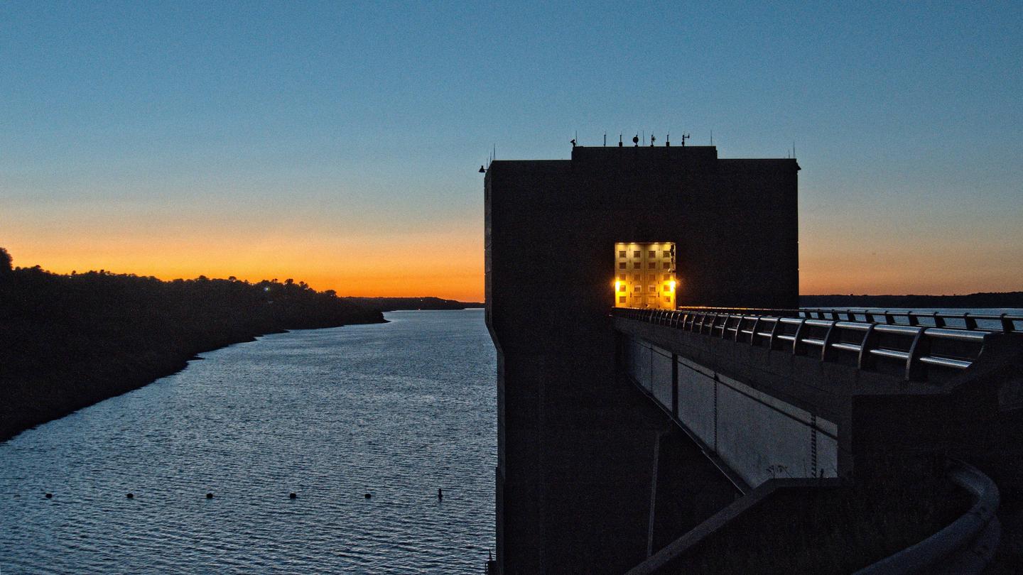 Dam tower at sunsetSunset at dam and lake