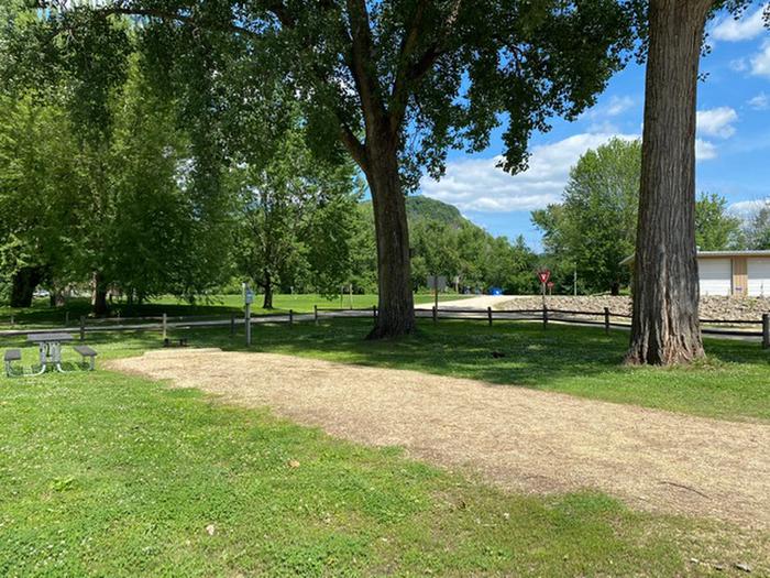 Site 17Close to main boat launch and interpretive building.  Grassy area behind and next to gravel pad with split rail fence between lawn and road behind site and to the side of the site.  Nice large mature trees.